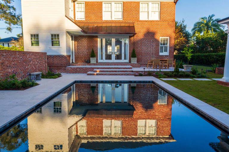 A house with a pool and a brick wall in Jacksonville, FL.